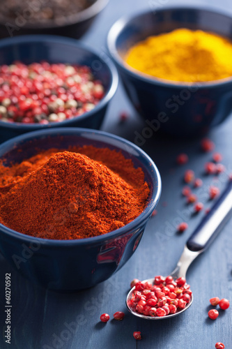 Photo: spices in bowls: curry, pink and black pepper, paprika powder spices in bowls: curry, pink and black pepper, paprika powder