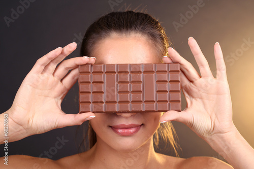 Photo: Portrait of beautiful young girl with chocolate Portrait of beautiful young girl with chocolate