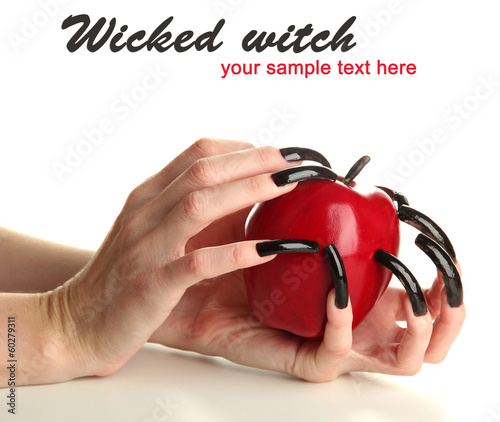 Photo: Hands with scary manicure holding red apple, isolated on white Hands with scary manicure holding red apple, isolated on white