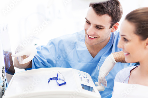 Photo: Dentist showing x-rays to patient Dentist showing x-rays to patient