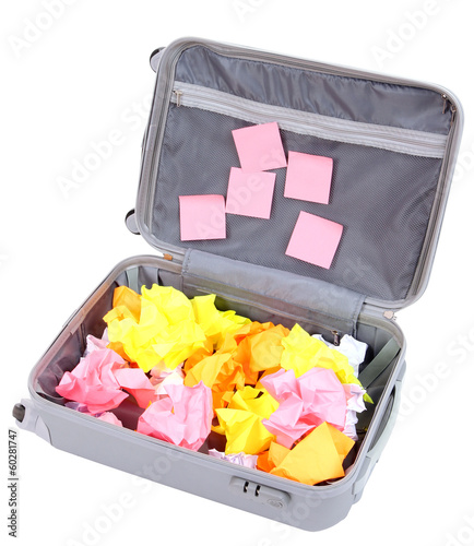 Photo: Open suitcase with paper stickers isolated on white Open suitcase with paper stickers isolated on white