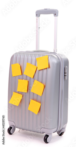 Photo: Suitcase with paper stickers isolated on white Suitcase with paper stickers isolated on white