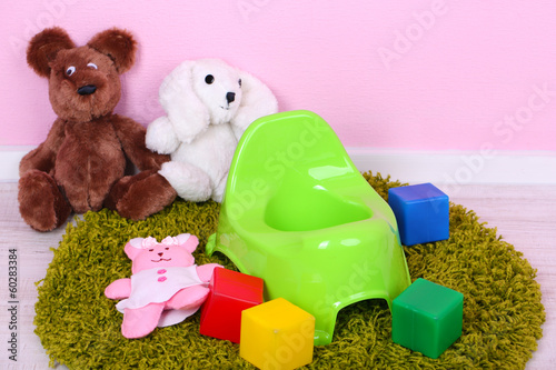 Photo: Green potty on home interior background Green potty on home interior background