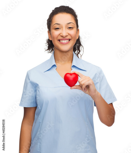 Photo: smiling female doctor or nurse with heart smiling female doctor or nurse with heart