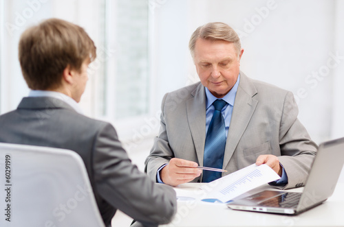 Photo: older man and young man having meeting in office older man and young man having meeting in office