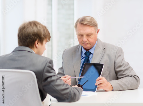 Photo: older man and young man with tablet pc older man and young man with tablet pc