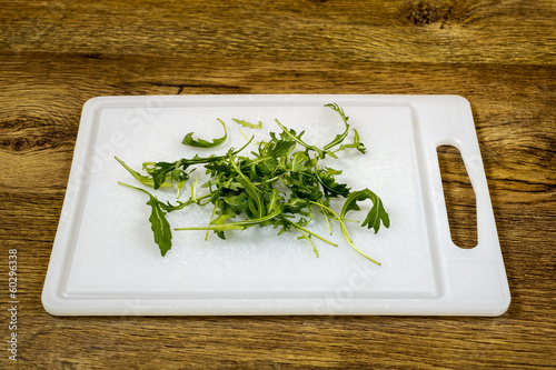 Photo: old green salad on plastic board old green salad on plastic board