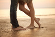 A loving young couple hugging and kissing on the beach. Lovers m A loving young couple hugging and kissing on the beach. Lovers m