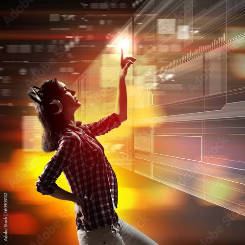 Photo: Woman touching virtual screen Woman touching virtual screen