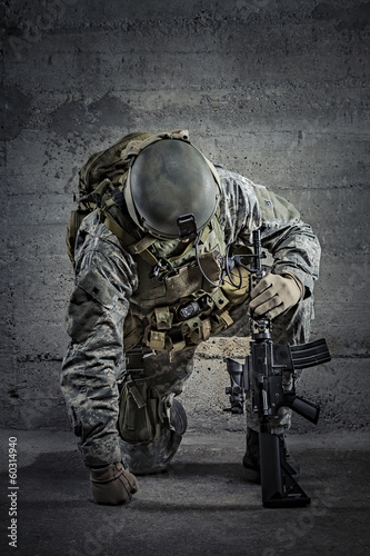 Photo: Soldier with rifle and helmet Soldier with rifle and helmet