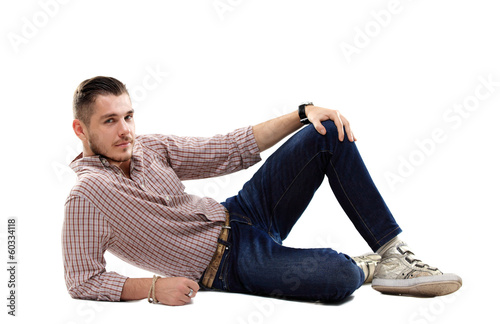 Photo: Flirtatious man sitting on the floor Flirtatious man sitting on the floor