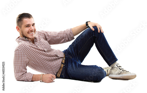 Photo: Flirtatious man sitting on the floor Flirtatious man sitting on the floor