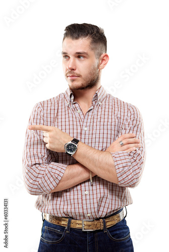 Photo: Portrait of a smiling man pointing his finger on the copyspace Portrait of a smiling man pointing his finger on the copyspace