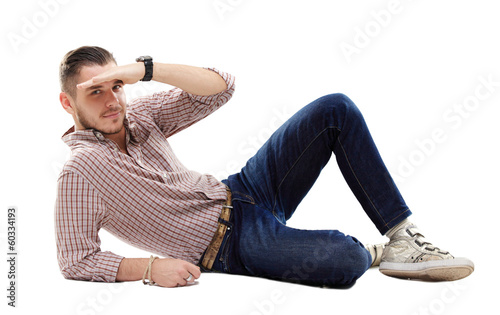 Photo: Flirtatious man sitting on the floor Flirtatious man sitting on the floor