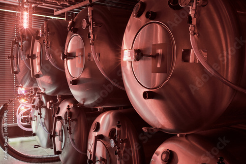 Photo: Horizontal tanks at brewery in red light Horizontal tanks at brewery in red light