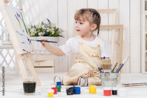Photo: Little girl artist paints in his studio Little girl artist paints in his studio