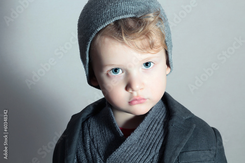Photo: Fashionable Little Boy in Cap.Fashion Handsome blond Child Fashionable Little Boy in Cap.Fashion Handsome blond Child