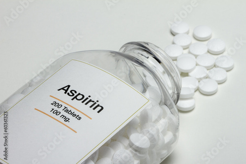 Photo: Aspirin bottle fallen over with pills, horizontal Aspirin bottle fallen over with pills, horizontal