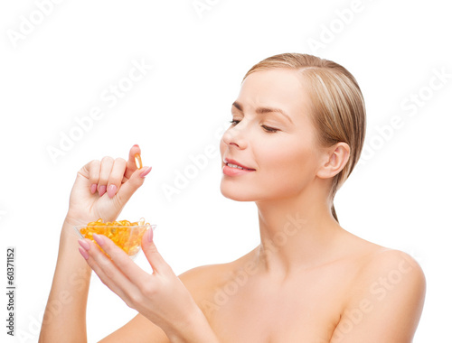 Photo: lovely woman with omega 3 vitamins lovely woman with omega 3 vitamins