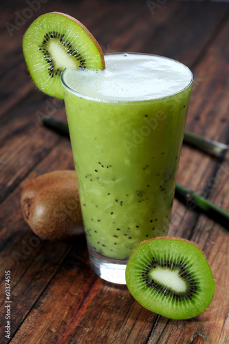 Photo: Kiwi juice on wooden background Kiwi juice on wooden background