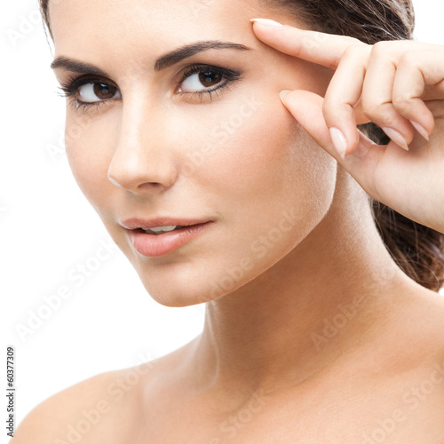 Photo: Woman touching skin or applying cream, isolated Woman touching skin or applying cream, isolated