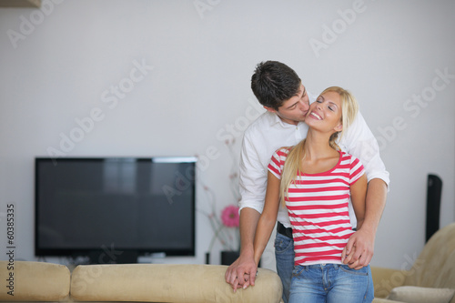 Photo: Relaxed young couple watching tv at home Relaxed young couple watching tv at home