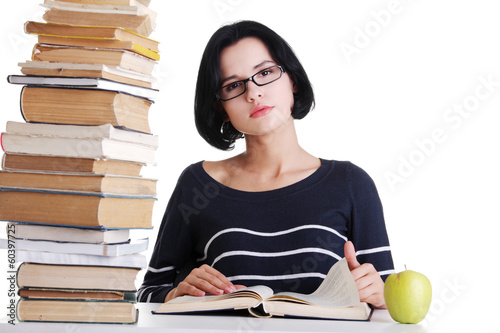 Photo: Young student woman studying at the desk Young student woman studying at the desk