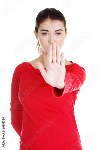 Photo: Hold on, Stop gesture showed by young woman Hold on, Stop gesture showed by young woman