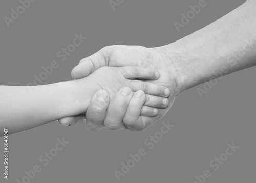 Photo: hands of father and son on a gray background hands of father and son on a gray background