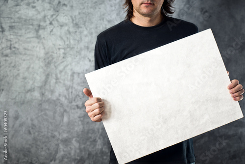 Photo: Man holding white banner Man holding white banner