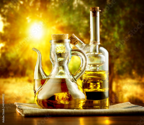Photo: Olive Oil on the Table in Garden of Olive Trees Olive Oil on the Table in Garden of Olive Trees
