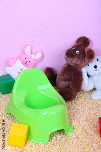 Photo: Green potty on home interior background Green potty on home interior background