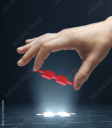 Photo: hand holding puzzle hand holding puzzle