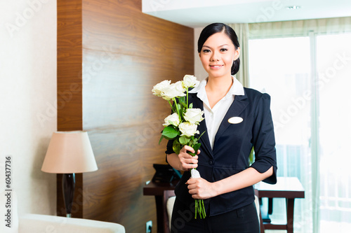 Photo: Asian Chinese hotel manager welcomes arriving VIP guests Asian Chinese hotel manager welcomes arriving VIP guests