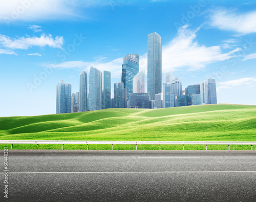 Photo: Asphalt road and modern city Asphalt road and modern city