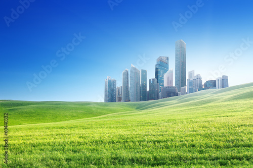 Photo: spring field and modern city spring field and modern city
