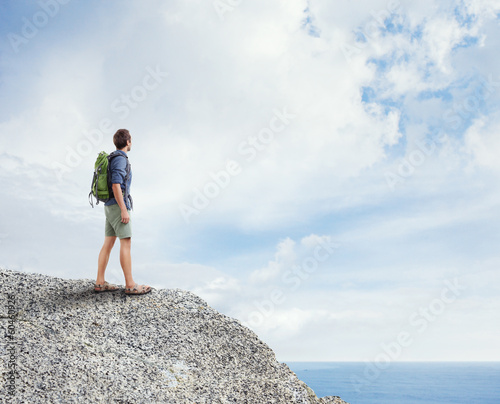 Photo: Young traveler standing on a rock Young traveler standing on a rock