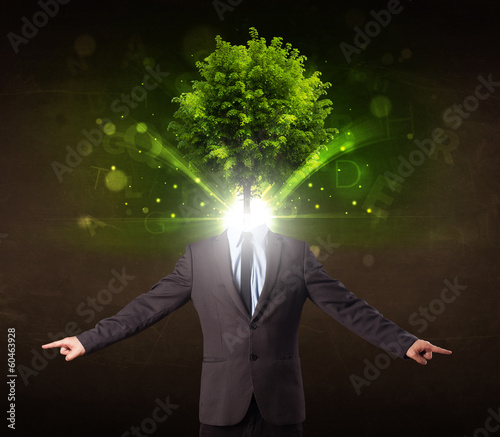 Photo: Man with green tree head concept Man with green tree head concept