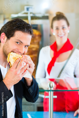 Photo: Kebab - customer and hot Doner with fresh ingredients Kebab - customer and hot Doner with fresh ingredients