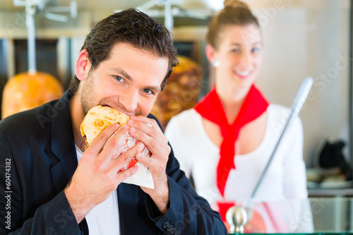 Photo: Kebab - customer and hot Doner with fresh ingredients Kebab - customer and hot Doner with fresh ingredients