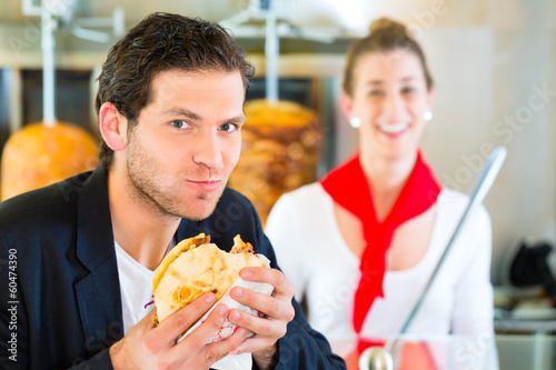 Photo: Kebab - customer and hot Doner with fresh ingredients Kebab - customer and hot Doner with fresh ingredients