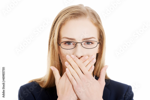 Photo: Beautiful business woman is covering her mouth. Beautiful business woman is covering her mouth.
