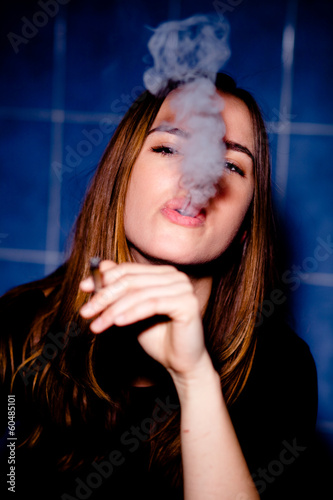 Photo: Young woman smoking a joint Young woman smoking a joint