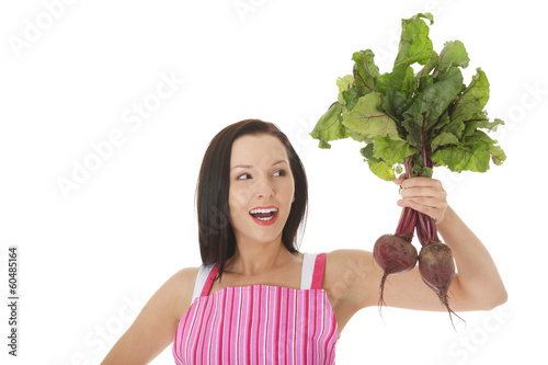 Photo: Young woman in apron and holding beetroots. Young woman in apron and holding beetroots.