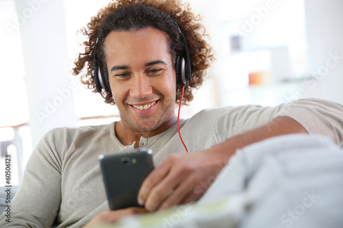 Photo: Cheerful attractive man listening to music Cheerful attractive man listening to music
