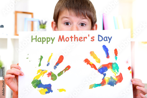 Photo: Cute little boy with his colorful handprint Cute little boy with his colorful handprint