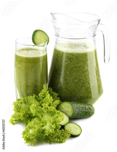 Photo: Glass and jug of green vegetable juice with cucumber isolated Glass and jug of green vegetable juice with cucumber isolated