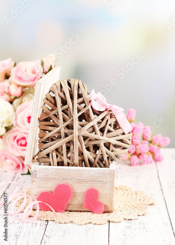 Photo: Romantic still life with heart in wooden casket Romantic still life with heart in wooden casket