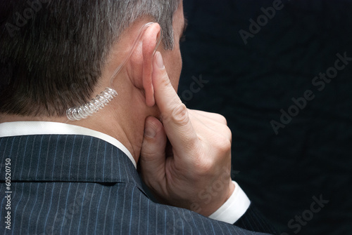 Photo: Secret Service Agent Listens To Earpiece, Shoulder Secret Service Agent Listens To Earpiece, Shoulder
