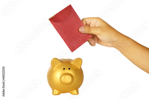 Photo: Insert Red Envelope Into Piggy Bank Insert Red Envelope Into Piggy Bank